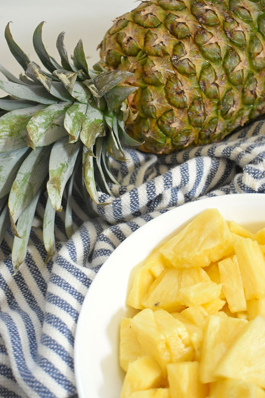 Pineapple, whole and chopped in a bowl